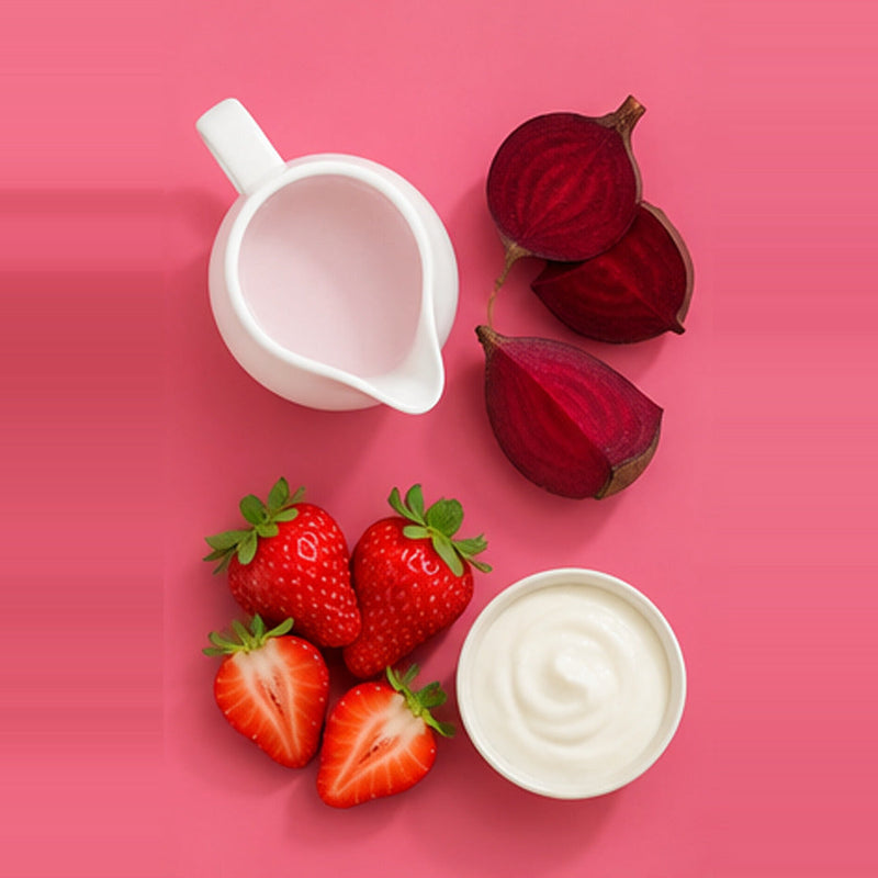 Beetroot berry yogurt smoothie ingredients: beetroot, strawberries, yogurt and milk on a pastel pink background