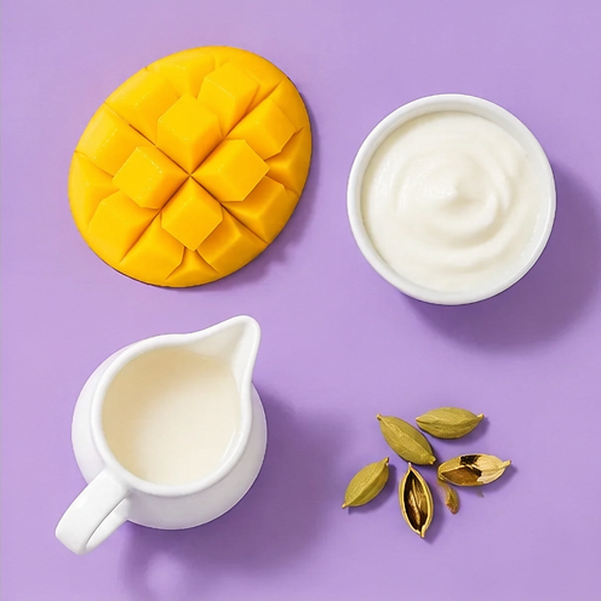 Flat-lay of mango, plain yogurt, milk and cardamom on a lavender background
