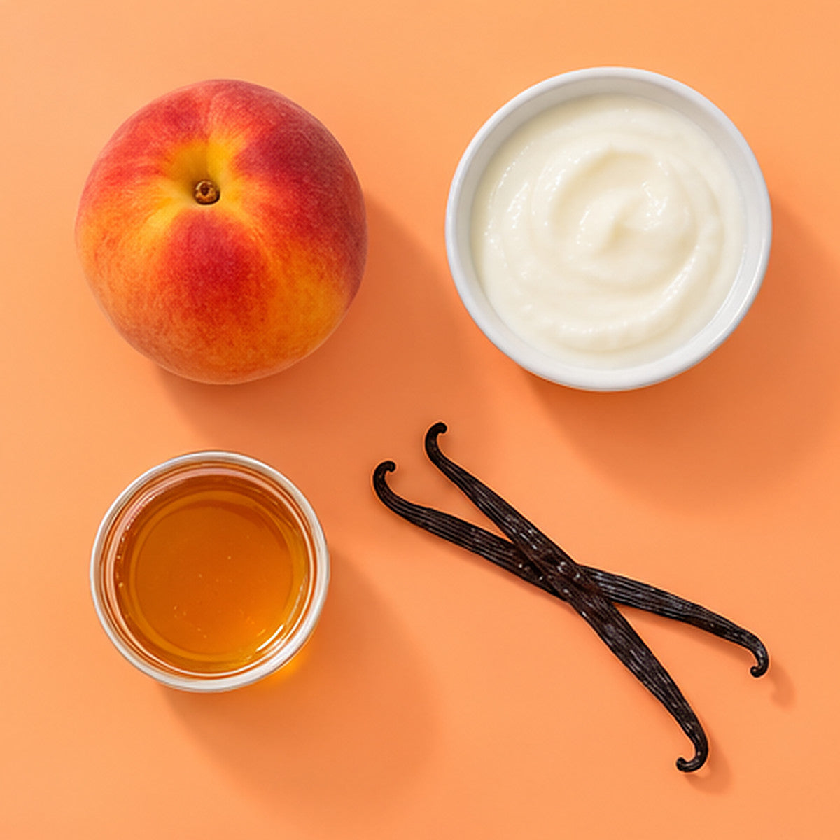 Flat-lay of peach, yogurt, vanilla and honey on a peach-orange background